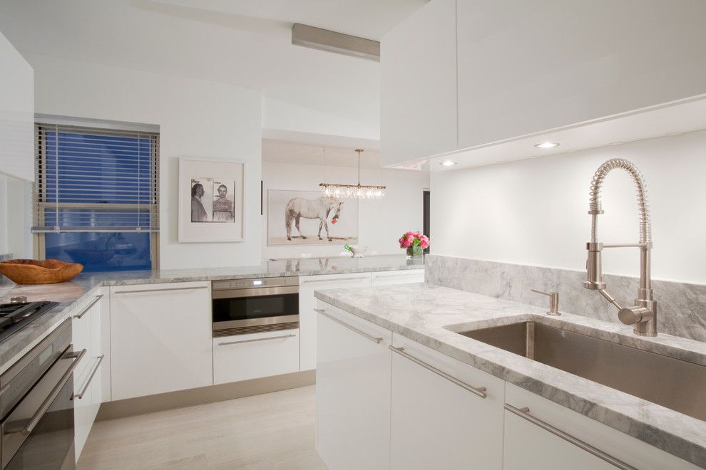 Quartz vs Granite Countertops for a Scandinavian Kitchen with a Porcelanosa White Kitchen Cabinets and 57th Street Residence by Glickman Schlesinger Architects