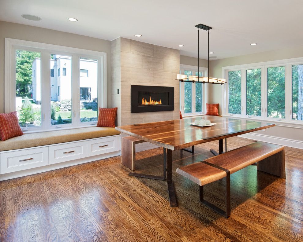 Regency Fireplaces for a Contemporary Dining Room with a Wood Floor and Dining Room by Southam Design Inc