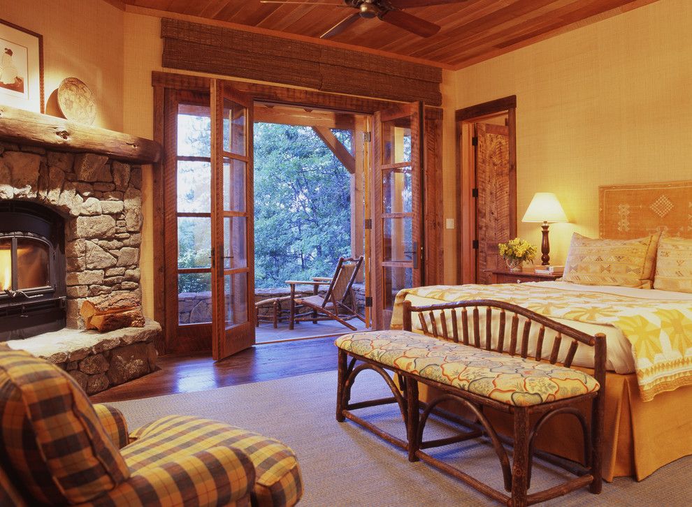 Regency Fireplaces for a Rustic Bedroom with a Dark Floor and Family Ranch by Tucker & Marks