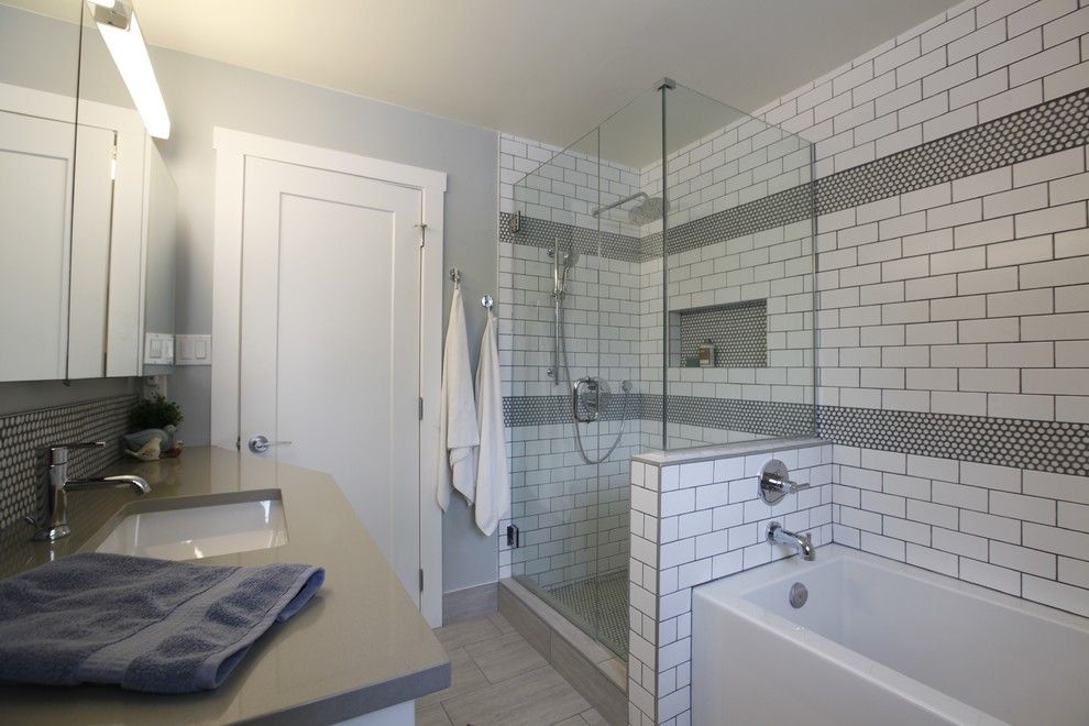 Retro Renovation for a Midcentury Bathroom with a Round Penny Tile and Retro Modern Renovation by Flawless Interiors Inc.