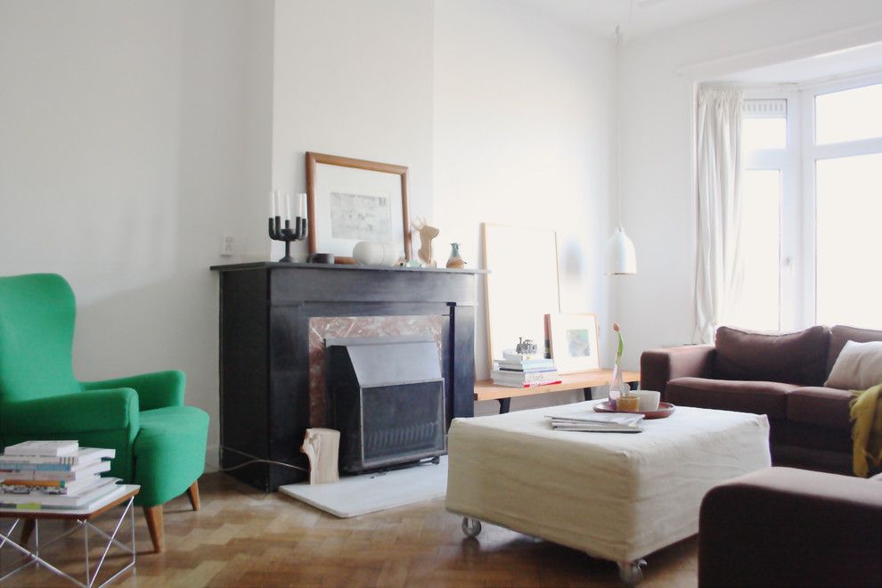 Reupholstered for a Eclectic Living Room with a Fireplace and the Home of Edwin by Holly Marder