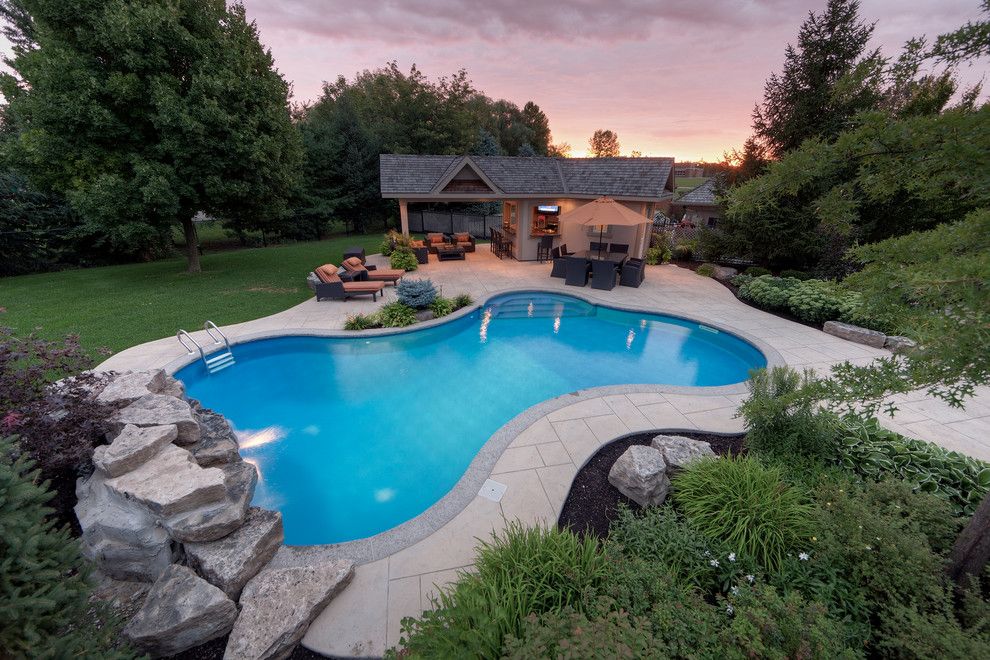 Rising Sun Pools for a Contemporary Pool with a Grass and Spacious Outdoor Living by Betz Pools Limited