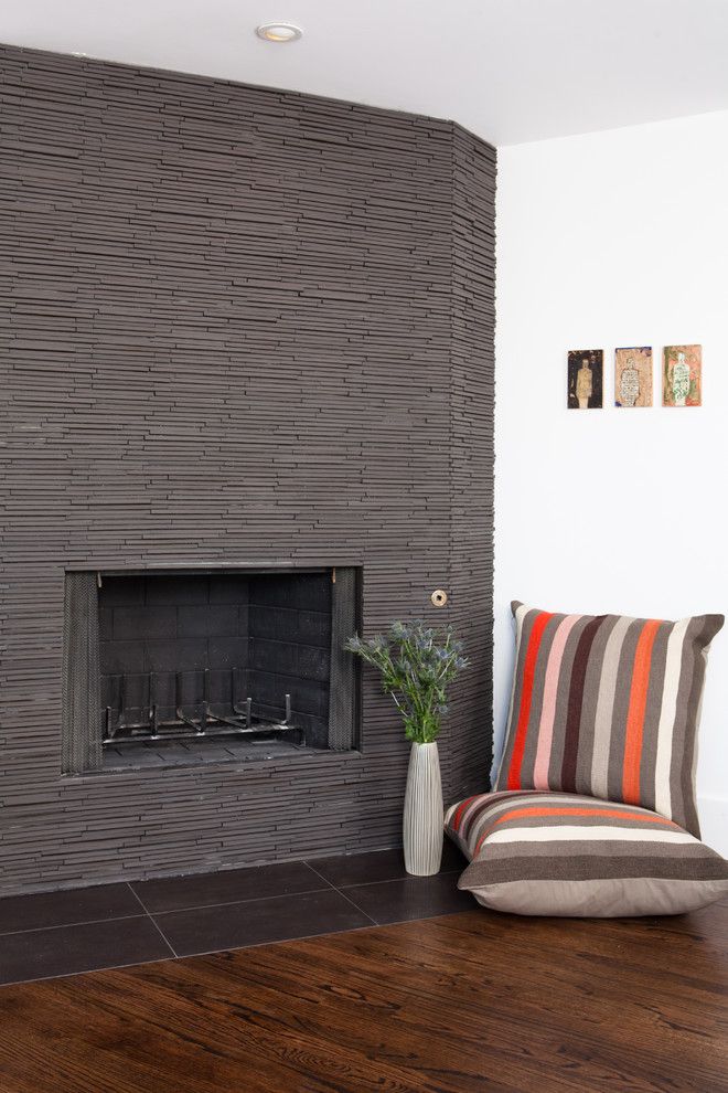 Roca Tile for a Midcentury Dining Room with a Dark Tile and Rustic Modern Fireplace by Regan Baker Design