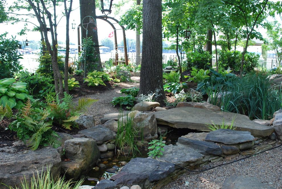 Ryan Lawn and Tree for a Traditional Landscape with a Arch Trellis and Woodland Back Garden Reno on Lake Norman. by Jay Sifford Garden Design