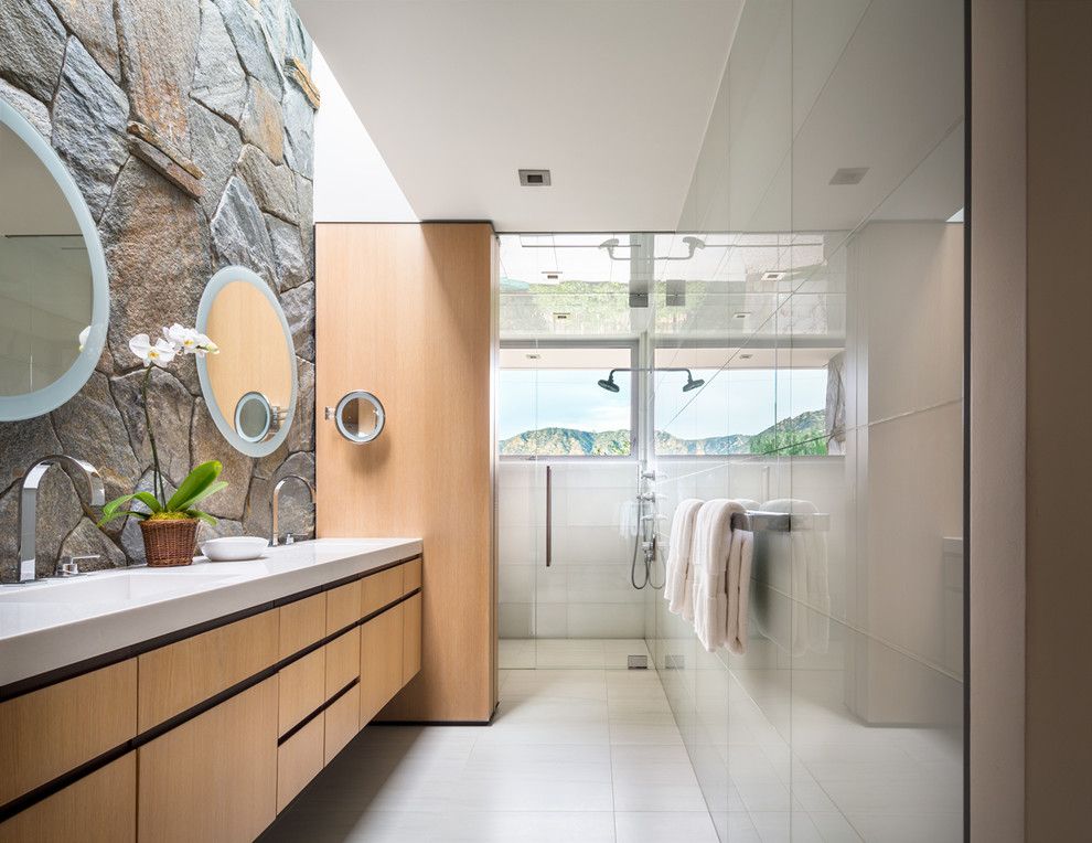 Schmitt Furniture for a Contemporary Bathroom with a Stone Wall and Guest Bath by Studio Bracket