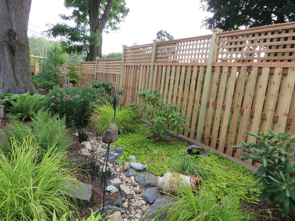 Shadowbox Fence for a Contemporary Exterior with a Fence and Western Red Cedar Shadowbox with Lattice Top by the Fence Experts