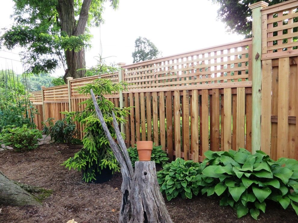 Shadowbox Fence for a Contemporary Exterior with a Picket Fence and Western Red Cedar Shadowbox with Lattice Top by the Fence Experts