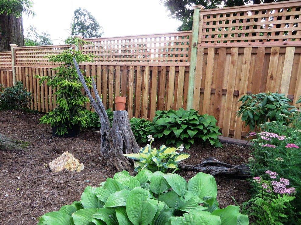 Shadowbox Fence for a Contemporary Exterior with a Semi Privacy Fence and Western Red Cedar Shadowbox with Lattice Top by the Fence Experts