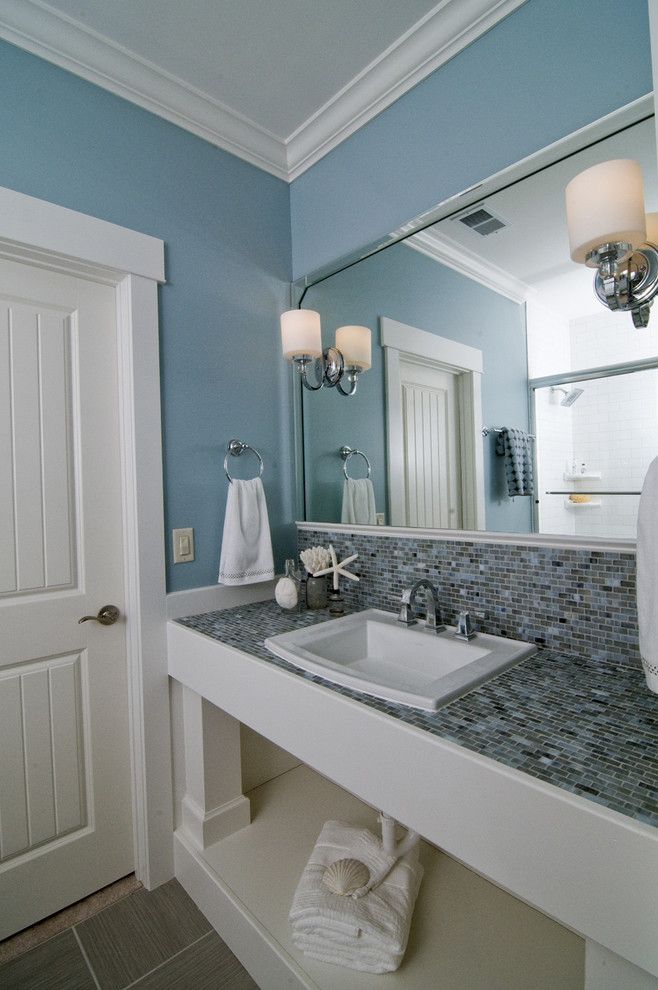 Sherwin Williams Pure White for a Beach Style Bathroom with a Open Shelves and Coastal Retreat Guest Bath by Southern Studio Interior Design