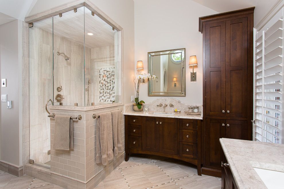 Shower Doors and Enclosures for a Traditional Bathroom with a Dark Wood Bathroom Vanity and Huntcliff Cliff Master Bath by Kitchen + Bath Artisans