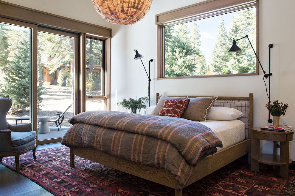 Sierra Pacific Windows for a Rustic Bedroom with a Wingback Chair and Butterfly Cabin by Ward Young Architecture & Planning   Truckee, Ca