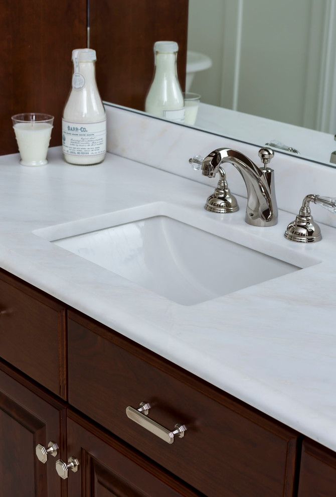 Sigma Faucets for a Traditional Bathroom with a Honed Marble and Elegant Family Home by Cadenza Granite and Marble