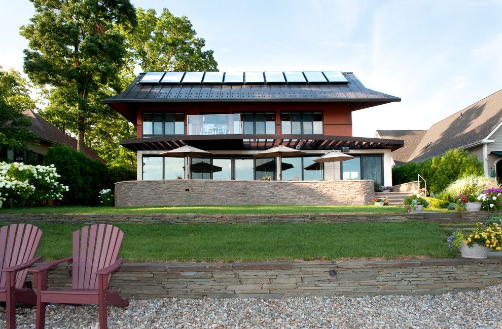 Simple Solar Homesteading for a Contemporary Exterior with a Stone Wall and Lake Front Home, Burlington, Vermont by Mary Prince Photography