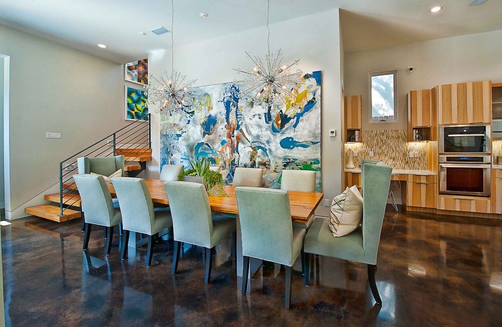 Stained Concrete Floors for a Contemporary Dining Room with a Artwork and Bowman Dining by Cornerstone Architects