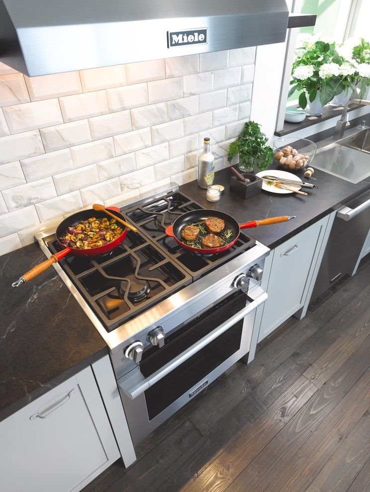 Stained Concrete Floors for a Contemporary Kitchen with a Black Countertop and Miele by Miele Appliance Inc