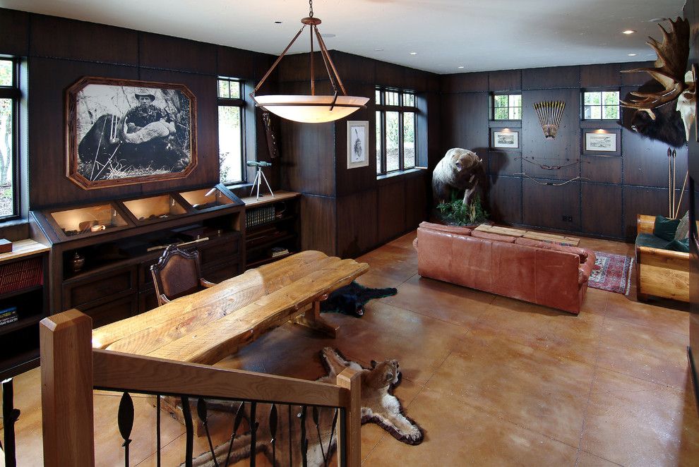 Stained Concrete Floors for a Traditional Family Room with a Trestle Table and Wild Game Room by Visbeen Architects