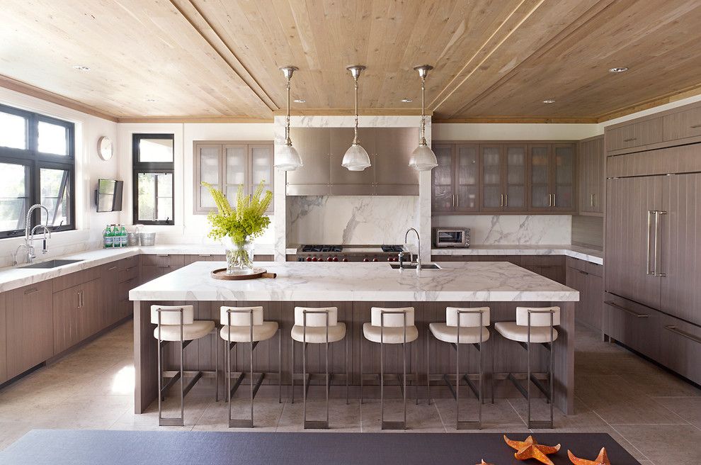 Statuary Marble for a Contemporary Kitchen with a White Pendant Lights and Hampton Beach House by Stephens Design Group