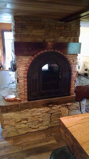 Stoll Fireplace for a Rustic Spaces with a Rustic Fireplace and See Through Fireplace Design, Side 1 by Stoneman Inc