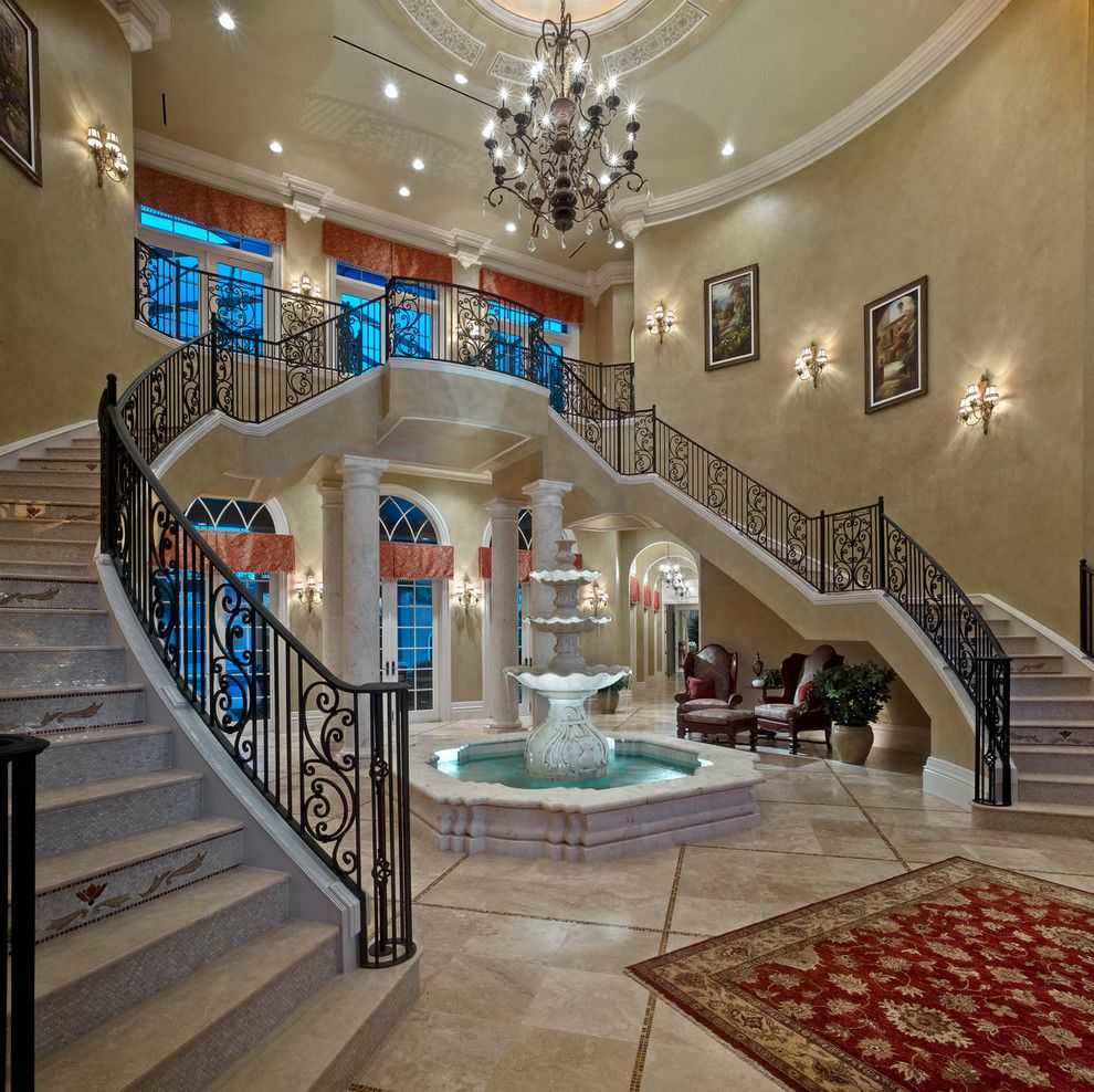 Stone Mart Tampa for a Mediterranean Staircase with a Arched Window and Mediterranean Staircase by Johncannonhomes.com