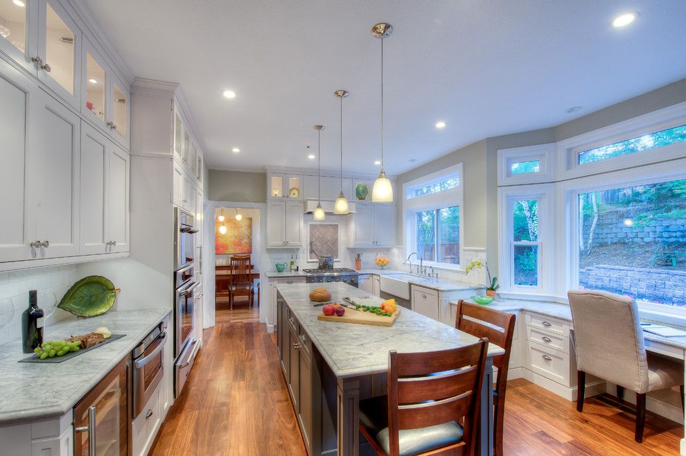 Super White Quartzite for a Traditional Kitchen with a Glass Cabinets and White and Grey Kitchen Remodel by Gloria Carlson   Harrell Remodeling, Inc.