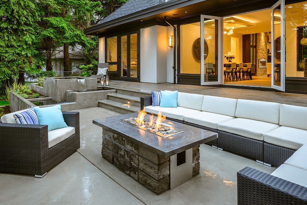 Tankless Water Heater vs Tank for a Contemporary Patio with a Fire and Water Features and Midland by Christopher Developments