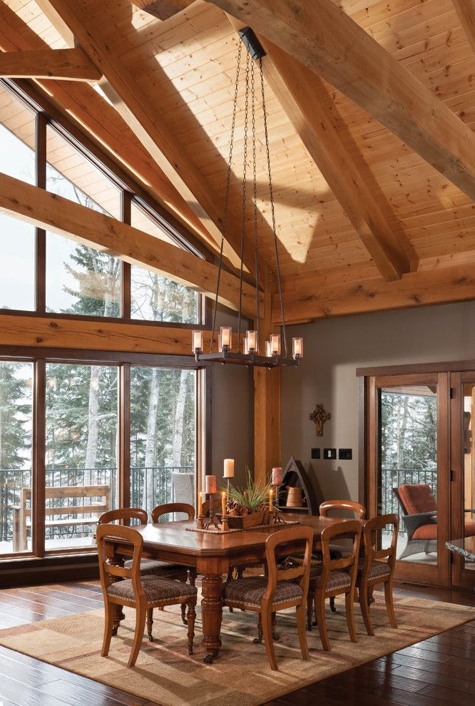 Timberpeg for a Rustic Dining Room with a Dining Room with a View and Mountain Timber Frame Home in Canada by Riverbend Timber Framing