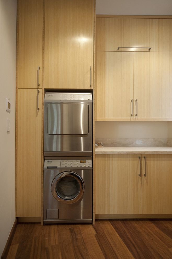 Top Load vs Front Load Washing Machine for a Contemporary Laundry Room with a Front Load Washer and Dryer and Malibu Home Remodel by Serrao Cabinets & Design