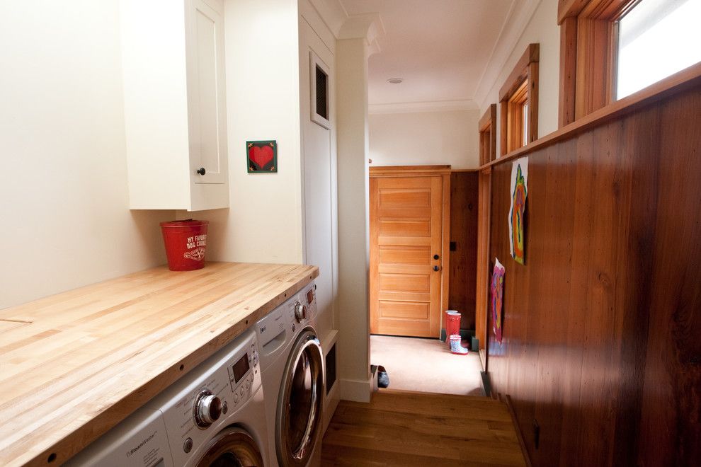 Top Load vs Front Load Washing Machine for a Traditional Laundry Room with a Wood Door and Pw Portfolio by Pecota White Building & Design