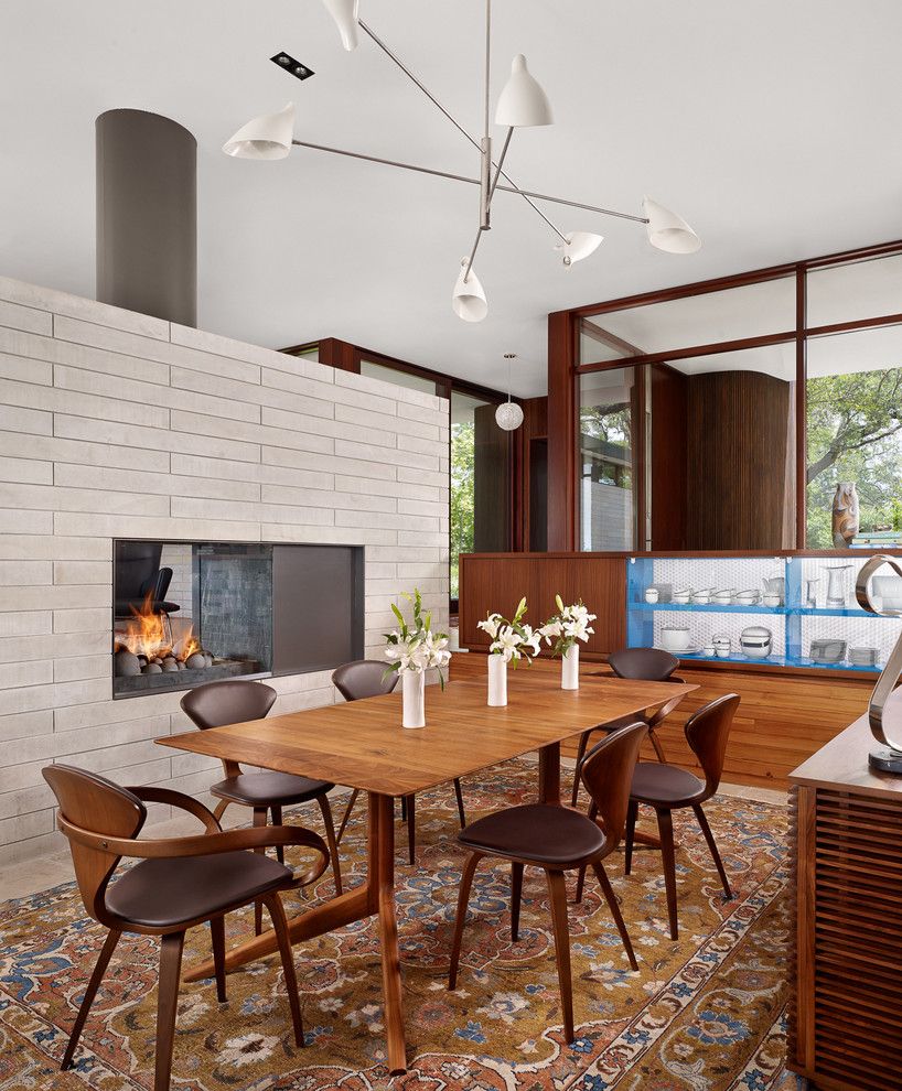 Vortex Doors for a Midcentury Dining Room with a Wood Dining Table and Lake View Residence by Alterstudio