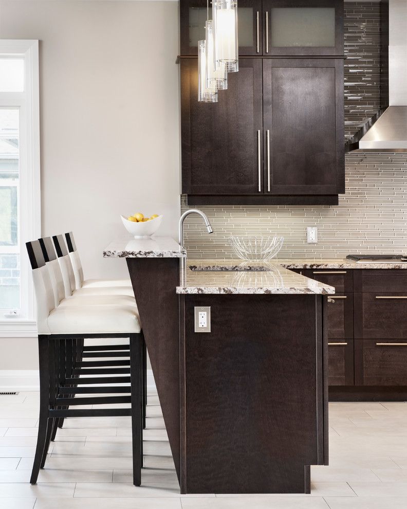 Vortex Doors for a Transitional Kitchen with a Bar Top and Pepper Kitchen by Laurysen Kitchens Ltd.