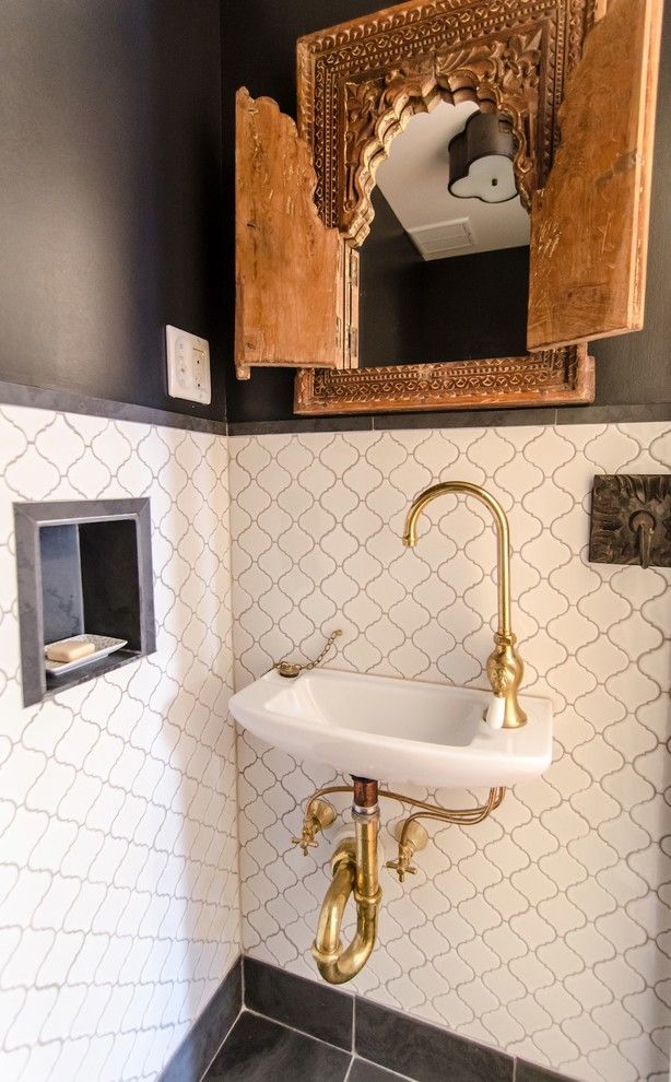 Wallington Plumbing Supply for a Mediterranean Powder Room with a Antique Carved Wooden Mirror Frame and Prospect Heights Brownstone by Indigo & Ochre Design