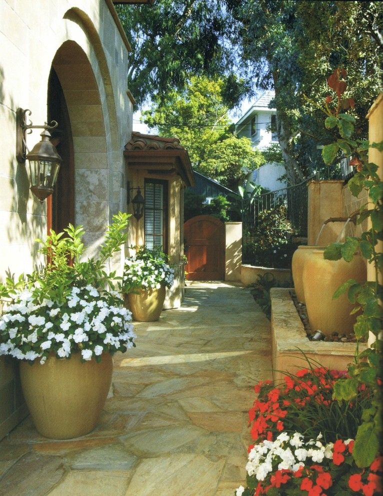 Water Spigot for a Mediterranean Landscape with a Wood Gate and Mediterranean Landscape by Environmentaldesignslandscape.com