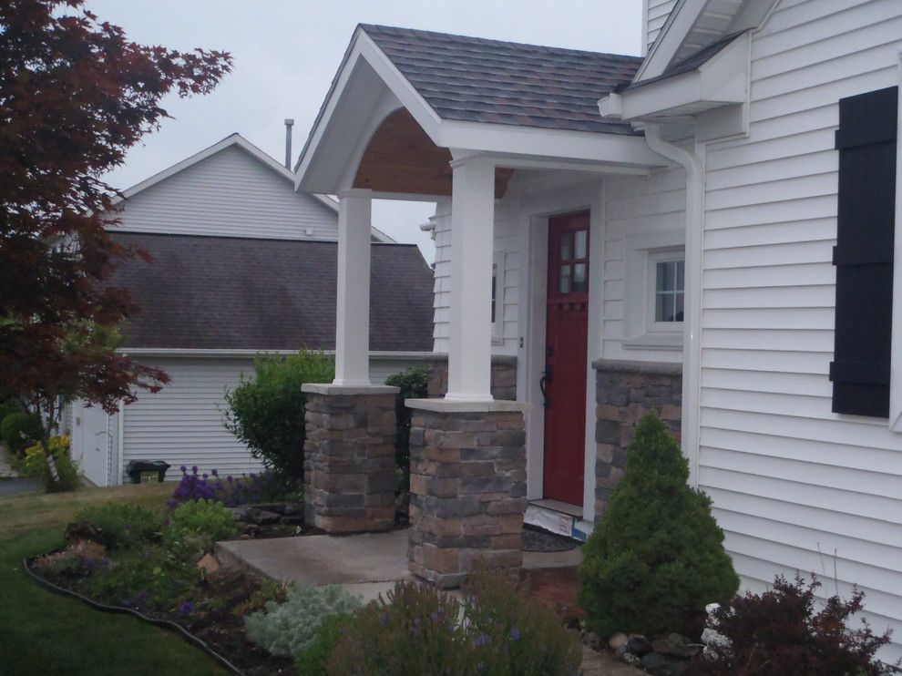 Waterfall Countertop for a Farmhouse Porch with a Door Canopy and Addition with Door Canopy and Stone Work by Bennett Contracting, Inc.