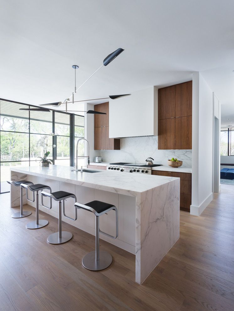 Waterfall Countertop for a  Kitchen with a Calcutta Gold Marble and Simply Modern by Tim Cuppett Architects