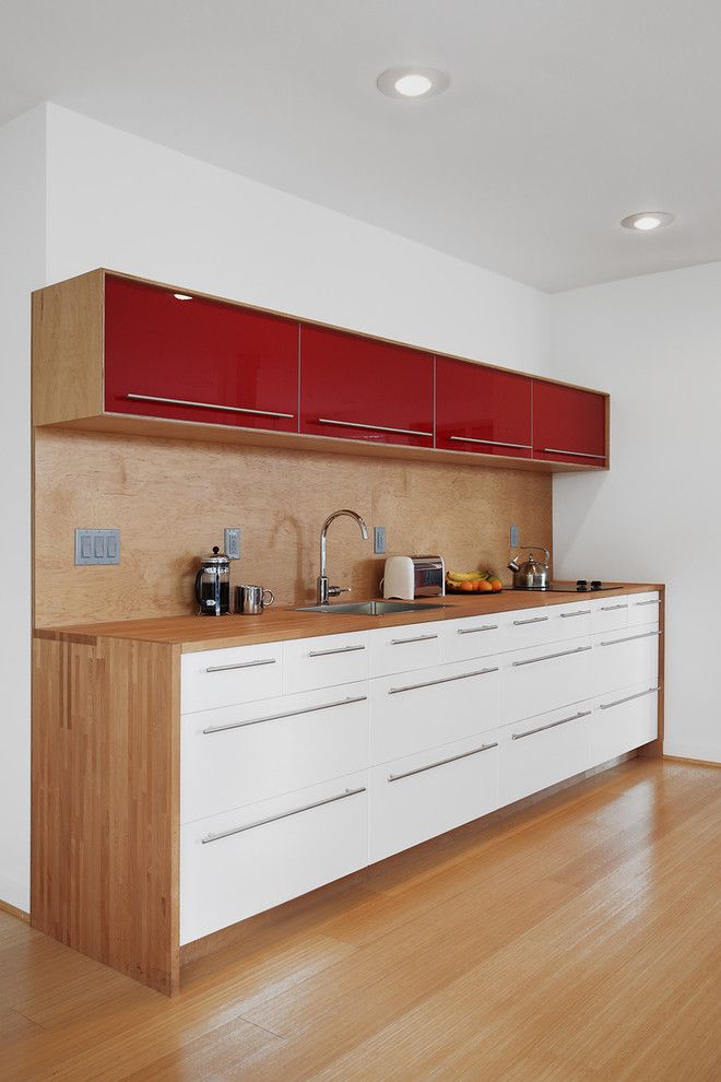 Waterfall Countertop for a Midcentury Kitchen with a Recessed Lighting and Leschi Renovation by Ambrose Construction Inc.