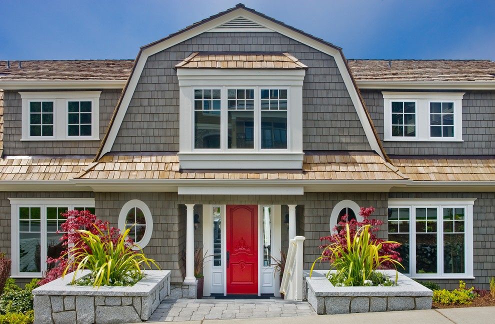 Weathered Wood Shingles for a Victorian Exterior with a Red Door and Glass by Gelotte Hommas Architecture