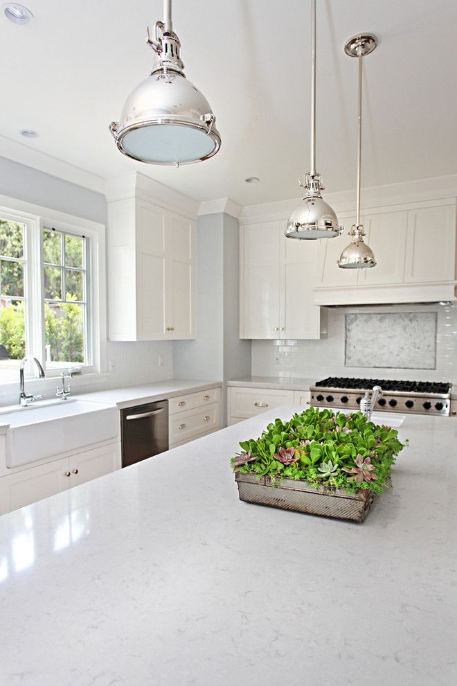 What is Silestone for a Transitional Kitchen with a Chrome Pendant Lights and Claridge by Brooke Wagner Design