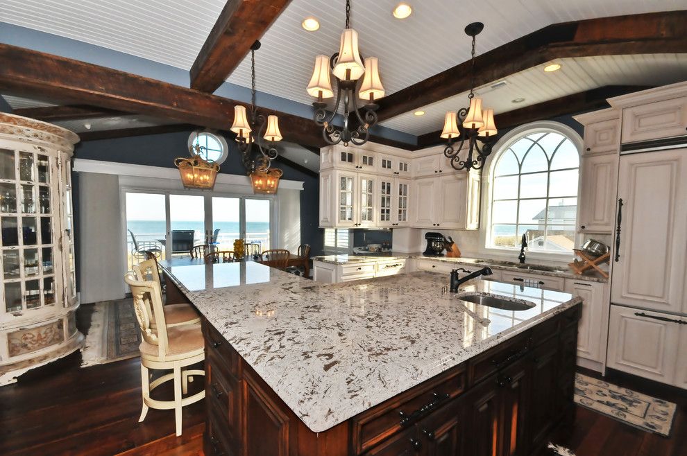 White Galaxy Granite for a Mediterranean Kitchen with a Breakfast Bar and Kitchen by Echelon Custom Homes