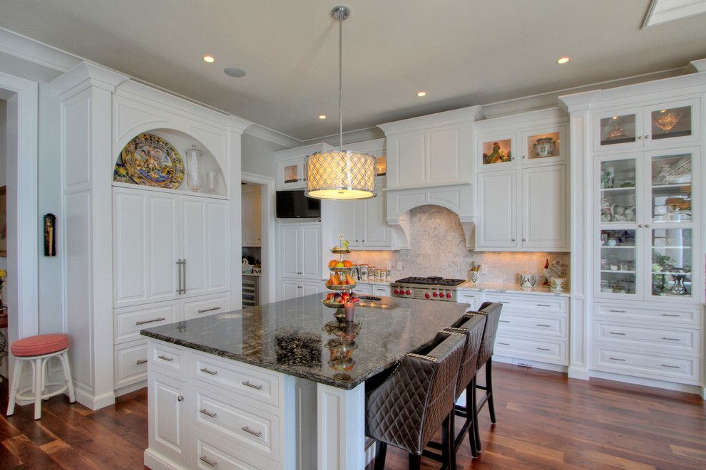 White Galaxy Granite for a Traditional Kitchen with a Carerra Marble Countertops and Classic White Kitchen by Palmetto Cabinet Studio