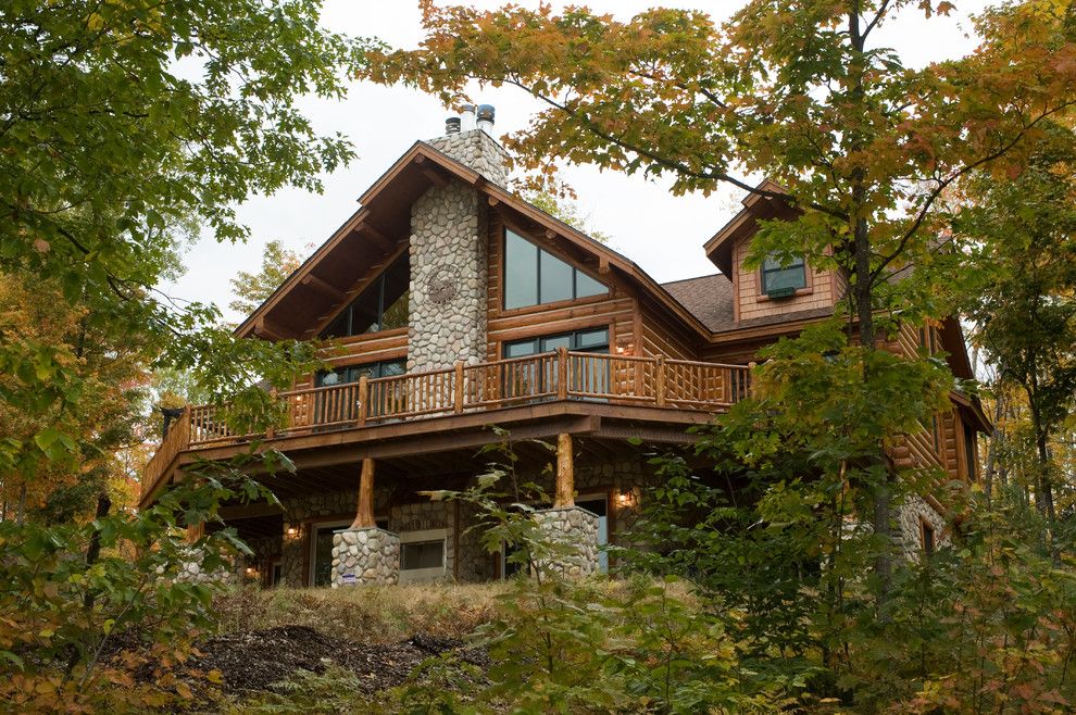 Woodhaven Lumber for a Rustic Exterior with a Log Siding and Flare Butt Cedar Deck Post by Woodhaven Log & Lumber