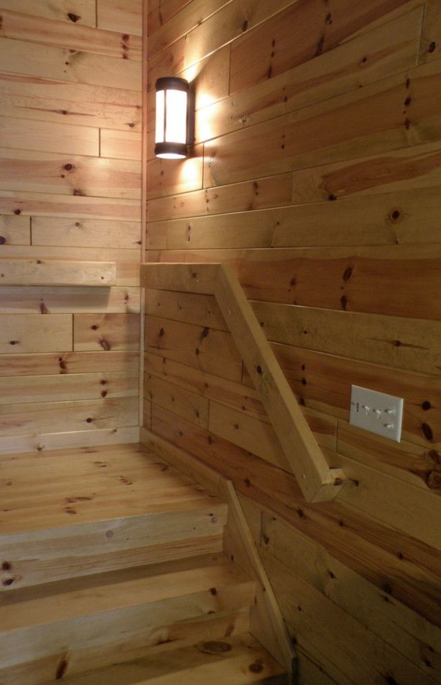 Woodhaven Lumber for a Rustic Spaces with a Tongue and Groove Paneling and Knotty Pine Paneling Staircase Landing by Woodhaven Log & Lumber