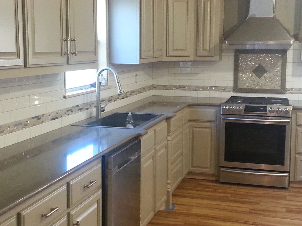 Zodiaq Quartz for a  Spaces with a Zodiaq Quartz Coarse Pepper with a Subway Tile with Quartz F and Zodiaq Quartz with Custom Tile Backsplash by Waters'  Specialty Countertops Inc.