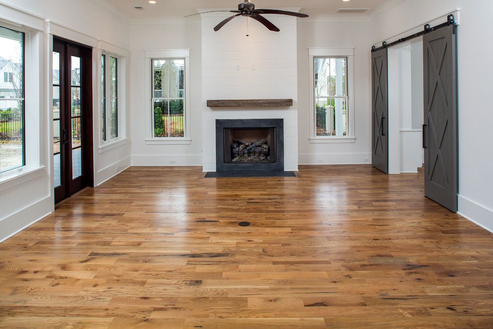 Charleston Forge for a Modern Family Room with a Reclaimed Wood Trusses and Simmons Forge 1, Daniel Island, South Carolina by Shelter Custom Built Living