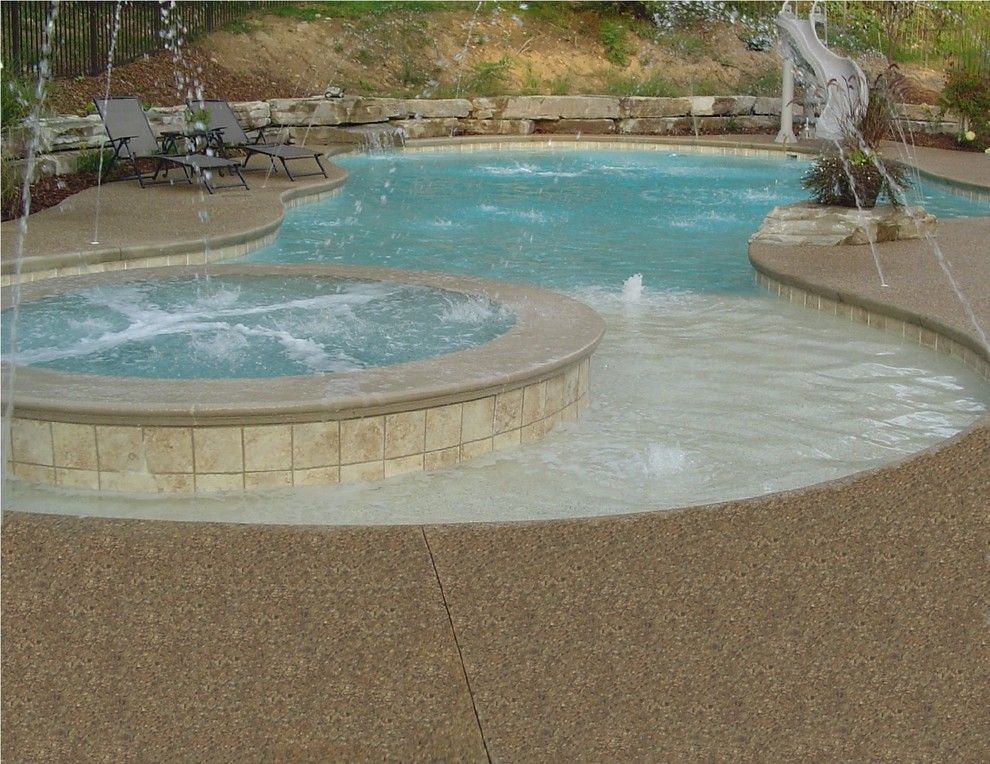 Exposed Aggregate Concrete for a Tropical Pool with a Pool Deck Ideas and Inground Swimming Pool Deck Around Gunite Pool in White Lake by Potoroka Concrete Decorative Surfaces