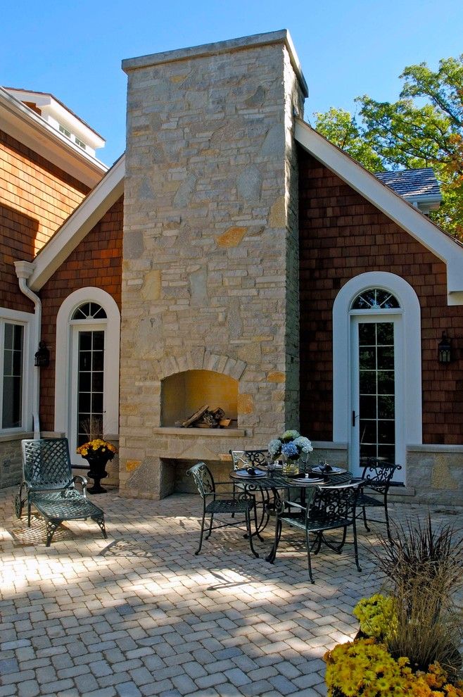 How to Build a Paver Patio for a Traditional Patio with a Arched Window and Nantucket Stone and Shingle Style Elegance in Lake Forest by Orren Pickell Building Group