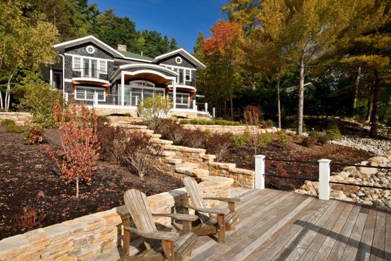 Roof Pitches for a Traditional Exterior with a Beadboard Ceiling and Legend of the Lake by Teakwood Builders, Inc.