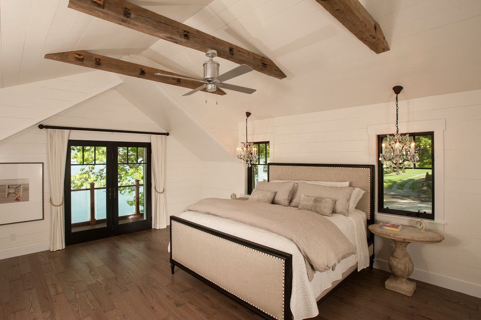 Schwing Electric for a Rustic Bedroom with a Beige Bedding and Lake George Retreat by Phinney Design Group