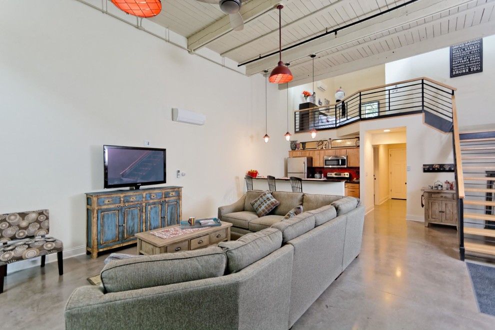 Southeastern Furniture for a Industrial Living Room with a Decorative Pillows and Window Factory Lofts by Viscusi Builders Ltd.