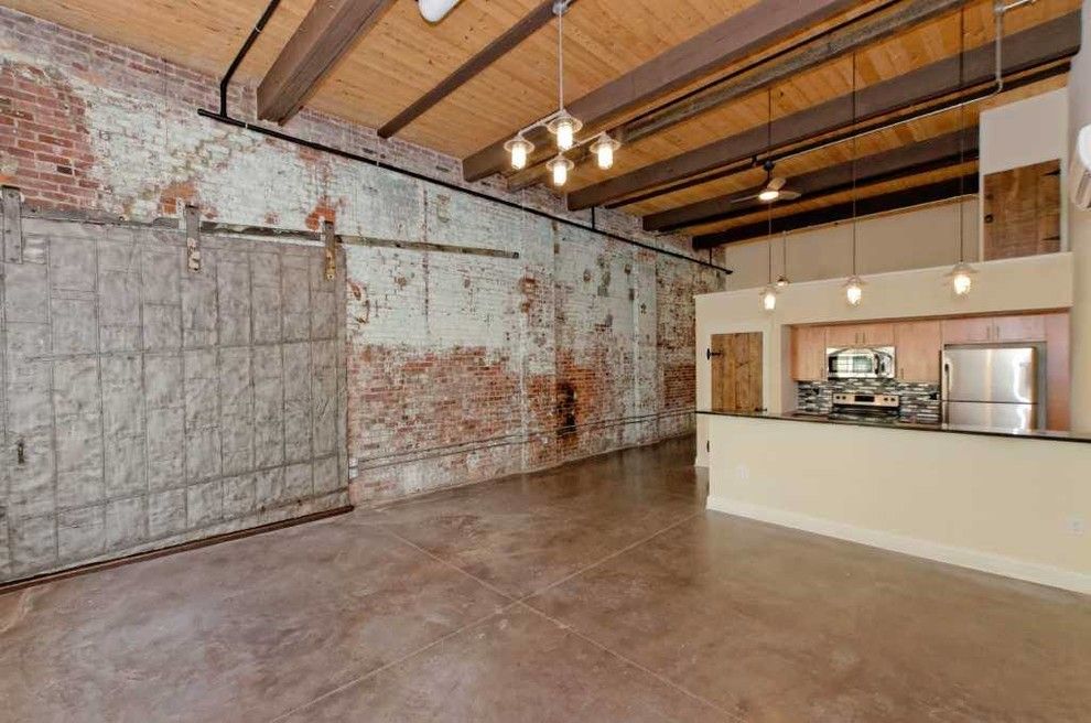 Stadium Lofts Anaheim for a Industrial Living Room with a Barn Door and Window Factory Lofts by Viscusi Builders Ltd.