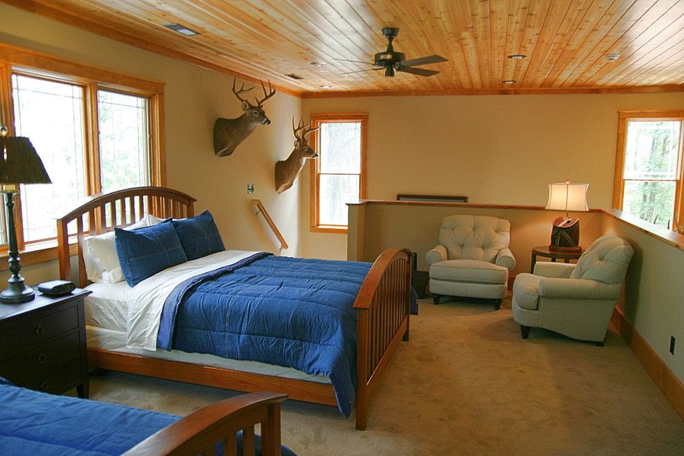 Stadium Lofts Anaheim for a Rustic Bedroom with a Beige Armchair and Hunting Cabin by Fowler Interiors